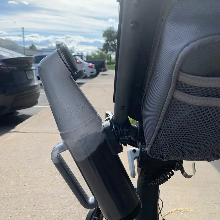 Action shot of sand bottle accessory attached to golf trundler
